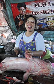 Market Woman chopping a big Catfish by Asienreisender